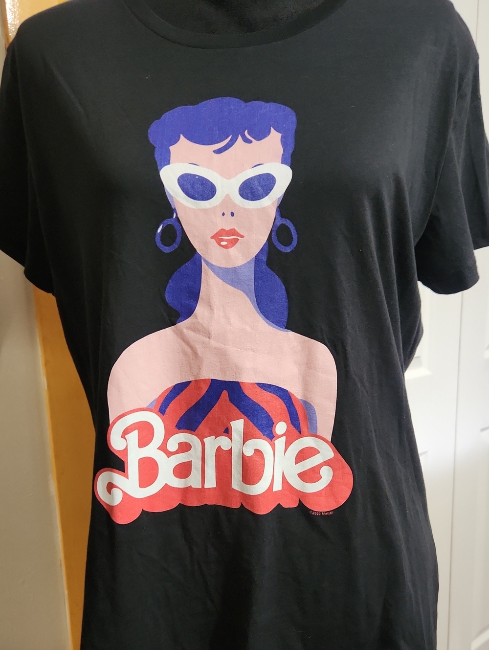Barbie Black Tee with Pink Skin Tone, Purple Hair and White Sunglasses Graphic